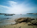 Summer Paradise: Boats Dot Serene Seascape with Golden Sunset & Sandy Beach Royalty Free Stock Photo