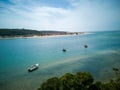 Summer Paradise: Boats Dot Serene Seascape with Golden Sunset & Sandy Beach