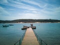 Summer Paradise: Boats Dot Serene Seascape with Golden Sunset & Sandy Beach