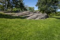 Summer park lawn with big rock, trees and day blue sky Royalty Free Stock Photo