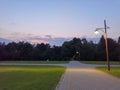 Summer park, Russia. Evening in the city Park. Lantern, trees, paths and lawn. in the background Royalty Free Stock Photo