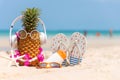 Summer in the party. Hipster Pineapple Fashion in sunglass and listen music with sunblock and sandal on the sand beach