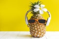 Summer in the party.  Hipster Pineapple Fashion in sunglass and music bright beautiful color in holiday, Creative art fruit for tr Royalty Free Stock Photo