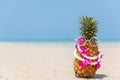 Summer in the party.  Hipster Pineapple Fashion in sunglass on the sand beach beautiful blue sky background. Royalty Free Stock Photo