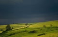 Summer pastoral landscape with a small chapel. Approaching storm, cloudy sky.