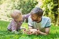 Summer photo happy father and son together lying on green grass