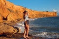 Summer photo of Sexy brunette girl with hat in fashion casual outfit enjpying on the beach at sunset. Freedom summertime vacation Royalty Free Stock Photo