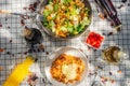 A summer picnic atmosphere, tablecloth on the lawn with plates of healthy food and fruit drinks. Flat lay food. Olive oil, salads Royalty Free Stock Photo