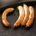 Summer picnic with barbeque sausages on black oven Royalty Free Stock Photo