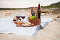 Picnic on the beach at sunset in the white plaid, food and drink