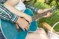 Summer picnic guy teaches girl to play guitar love warm tenderness