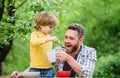 Summer picnic. Morning breakfast. family dinner time. happy fathers day. Little boy with dad eat cereal. healthy food Royalty Free Stock Photo