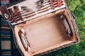 Summer picnic straw basket on green grass background. Top view. Copy space. Summer picnic time. Banner