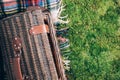 Summer picnic straw basket on green grass background. Top view. Copy space. Summer picnic time. Banner