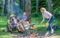 Summer picnic. Tourists hikers sit on log relaxing waiting picnic snack. Company having hike picnic nature background Royalty Free Stock Photo