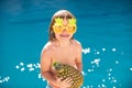 Summer pineapple fruit. Happy child having fun at swimming pool on sunny day. Kids summer holidays and vacation concept. Royalty Free Stock Photo