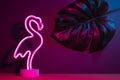 Summer pink flamingo and monstera leaf with neon pink and blue light.vacation background