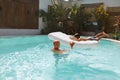 Summer Pool. Father And Son Enjoying Sunny Day. Little Boy Floating On Inflatable Water Mattress.