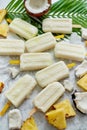 Summer popsicles on stick. Pinacolada flavour. Made with pineapple, cocount milk, rum. Vegan snack