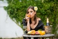 Summer portrait of beautiful fashion woman eating orange, summer fruits, outdoor. Beautiful woman enjoying spring Royalty Free Stock Photo