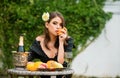 Summer portrait of beautiful fashion woman eating orange, summer fruits, outdoor. Beautiful woman enjoying spring Royalty Free Stock Photo
