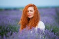 Summer portrait of a beautiful girl with long curly red hair Royalty Free Stock Photo