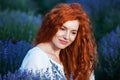 Summer portrait of a beautiful girl with long curly red hair Royalty Free Stock Photo