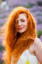 Summer portrait of a beautiful girl with long curly red hair Royalty Free Stock Photo