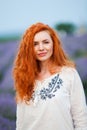 Summer portrait of a beautiful girl with long curly red hair Royalty Free Stock Photo