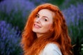 Summer portrait of a beautiful girl with long curly red hair Royalty Free Stock Photo