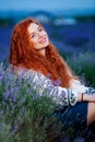 Summer portrait of a beautiful girl with long curly red hair Royalty Free Stock Photo