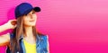 Summer portrait of beautiful young woman model wearing blue baseball cap on vivid pink background, banner blank copy space for Royalty Free Stock Photo