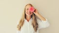 Summer portrait of caucasian happy smiling middle aged woman covering her eyes with pink rose flower buds on studio background Royalty Free Stock Photo
