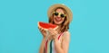 Summer portrait of happy laughing smiling young woman with slice of watermelon wearing straw hat on blue background Royalty Free Stock Photo