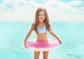 Summer portrait happy little girl child bathing with inflatable circle having fun Royalty Free Stock Photo