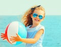 Summer portrait of happy smiling little girl child playing with inflatable water ball on beach over sea Royalty Free Stock Photo