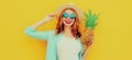 Summer portrait happy smiling woman with pineapple having fun wearing a straw hat, sunglasses over colorful yellow Royalty Free Stock Photo