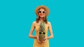 Summer portrait of happy smiling woman with pineapple wearing sunglasses, straw hat posing on blue background Royalty Free Stock Photo