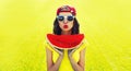 Summer portrait of happy smiling young woman eating fresh juicy slice of watermelon on the grass in the summer park Royalty Free Stock Photo