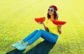 Summer portrait of happy smiling young woman eating fresh juicy slice of watermelon on the grass in the summer park Royalty Free Stock Photo