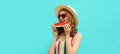 Summer portrait of happy smiling young woman eating a slice of watermelon wearing straw hat on blue background Royalty Free Stock Photo