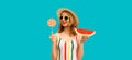 Summer portrait of happy smiling young woman with fresh juicy slice of watermelon and colorful lollipop sweet wearing straw hat, Royalty Free Stock Photo