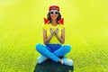 Summer portrait of happy smiling young woman with ice cream or lollipop shaped slice of watermelon on the grass in the summer park Royalty Free Stock Photo