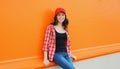 Summer portrait of happy smiling young woman posing in red baseball cap, casual clothes Royalty Free Stock Photo