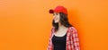 Summer portrait of happy smiling young woman posing in red baseball cap, casual clothes Royalty Free Stock Photo