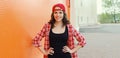 Summer portrait of happy smiling young woman posing in red baseball cap, casual clothes Royalty Free Stock Photo