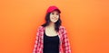 Summer portrait of happy smiling young woman posing in red baseball cap, casual clothes Royalty Free Stock Photo