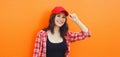 Summer portrait of happy smiling young woman posing in red baseball cap, casual clothes Royalty Free Stock Photo