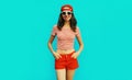 Summer portrait happy smiling young woman wearing baseball cap, red shorts on blue background Royalty Free Stock Photo