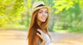 Summer portrait of happy smiling young woman wearing straw hat outdoors Royalty Free Stock Photo